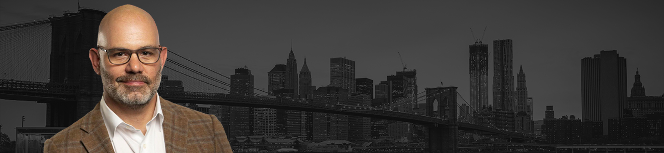 Jeremy Saland with Brooklyn Bridge and New York City buildings in the background.